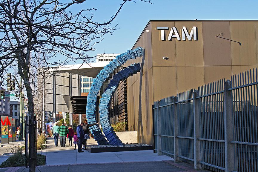 Blanket Stories along the TAM building on Pacific Avenue, showing two blue infinity loops comprised of bronze cast blankets