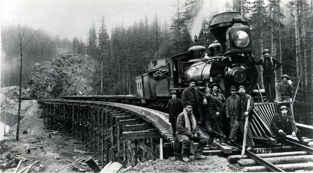 10 members of a Northern Pacific Railroad crew posing by locomotive no. 457 on the Stampede Tunnel line, in either King or Kittitas County, WA, ca. 1885. Courtesy Washington State Historical Society, 2015.0.316.